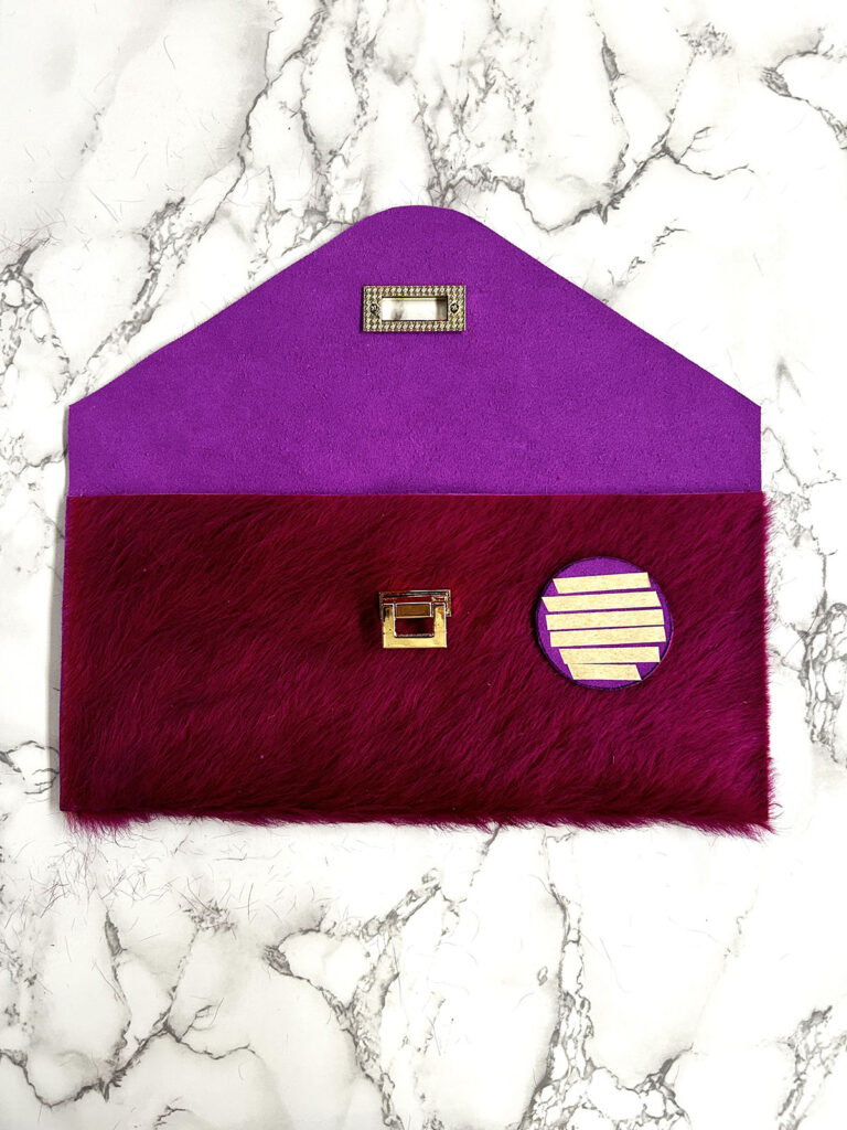 covering prongs on fur envelop clutch